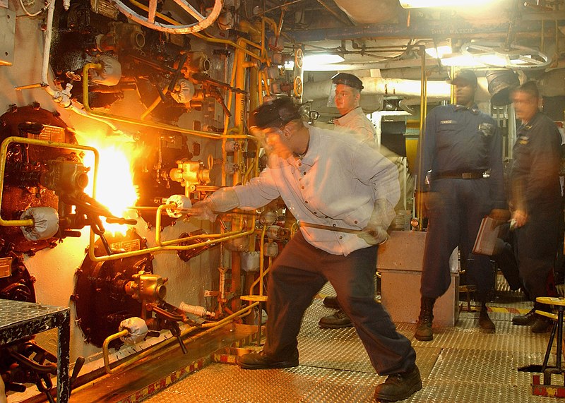 File:US Navy 030904-N-4190W-002 Machinist Mate 3rd Class Jose Fernandez, from Miami, Fla., ignites a boiler in a main machinery room aboard USS John F. Kennedy (CV 67).jpg