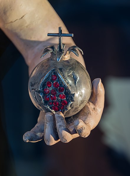 File:Pomegranate in hand of Jesus, Granada, Spain.jpg