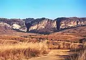 Pastel striated stone outcroppings jut from the plains