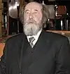 Aleksandr Solzhenitsyn with his mouth open and lower teeth on show