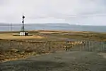 A view of the bay. Road and a radio tower in front.