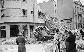 a damaged building and damaged tram