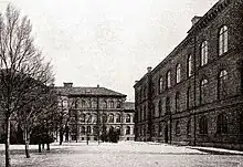 Photograph of two educational building surrounding a commons