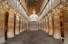 Cave with carved columns and a shrine in the middle