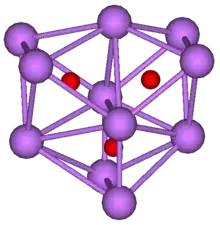 The stick and ball diagram shows three regular octahedra, which are connected to the next one by one surface and the last one shares one surface with the first. All three have one edge in common. All eleven vertices are purple spheres representing caesium, and at the center of each octahedron is a small red sphere representing oxygen.