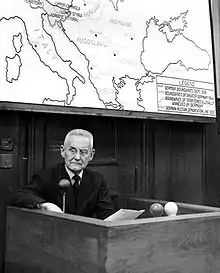 alt=Photograph of Halder sitting in a witness box looking to his right