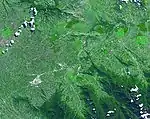 Satellite image of a green valley dominated by farming and agriculture