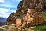 Stone church building, mountains in the background