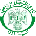 الشعار القديم للنادي والذي ظلت أقمصة الفريق تحمله مدة 53 سنة، أي منذ نشأته سنة 1949 قبل أن يتم تغييره سنة 2001، يُعتقَد أن مصمم الشعار هو الأب جيكو بنفسه الذي حرص على جعل النسر الجارح شعارا للنادي.