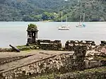 Ruins of stone fortifications near water.