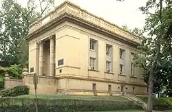 An oblique view of a large salmon colored two-story stone building, of some prominence