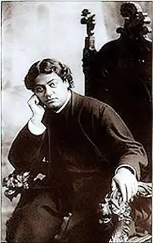 Image of Vivekananda relaxing in a chair.