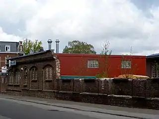 Alte Vorderwand der Maschinenhalle mit angebautem neuen Kantinengebäude; links im Hintergrund das Direktionsgebäude