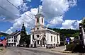 Kirche in der Ortsmitte; Links wo heute das weiße Gebäude steht, befand sich die religiöse Schule, wo George Coșbuc 1871–1872 die 1. Klasse besuchte.