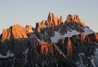 Der Kamm der Croda da Lago bei Sonnenuntergang. Im Vordergrund die Nordwestwände der Lastoni di Formin, dahinter ganz rechts die Cima Ambrizzola. Rechts der Bildmitte die Croda da Lago.