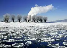 Eisgang auf der Weser, im Hintergrund Fahnen kondensierten Dampfes vom Kernkraftwerk Grohnde