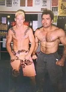 Rogan and Gerald Strebendt flexing in a ring