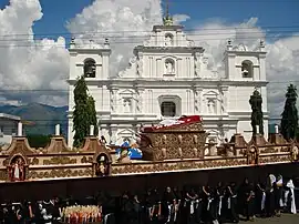 Prozession mit riesigem Traggerüst vor der im 19. Jahrhundert erbauten neuen Pfarrkirche