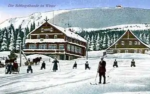 Die Alte und Neue Schlingelbaude im Winter auf einer Postkarte um 1900. Im Hintergrund auf der Anhöhe die Prinz‑Heinrich‑Baude