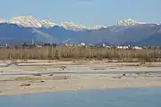 Der Fluss Tagliamento im Vordergrund und die Stadt Spilimbergo im Hintergrund.