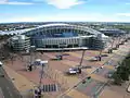 Der Sydney Olympic Park im Jahr 2007. Im Vordergrund das zurückgebaute Olympiastadion (damals: Telstra Stadium) und rechts dahinter die Acer Arena.