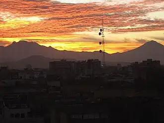 Der Paso de Cortez ist der tiefste Einschnitt rechts neben der Antenne. Der Berg links ist der Iztaccíhuatl, rechts ist der Popocatépetl