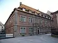 Sogenannter Petersbau, ehemals fürstbischöfliches Kollegiengebäude, 1691 errichtet, ab 1704 der westliche Teil als fürstbischöfliche Münze genutzt, 1884 Münzschule (später Peterschule; heute unter anderem Ort der Volkshochschule), der östliche Teil als Priesterwohnung, heute katholisches Pfarramt St. Peter